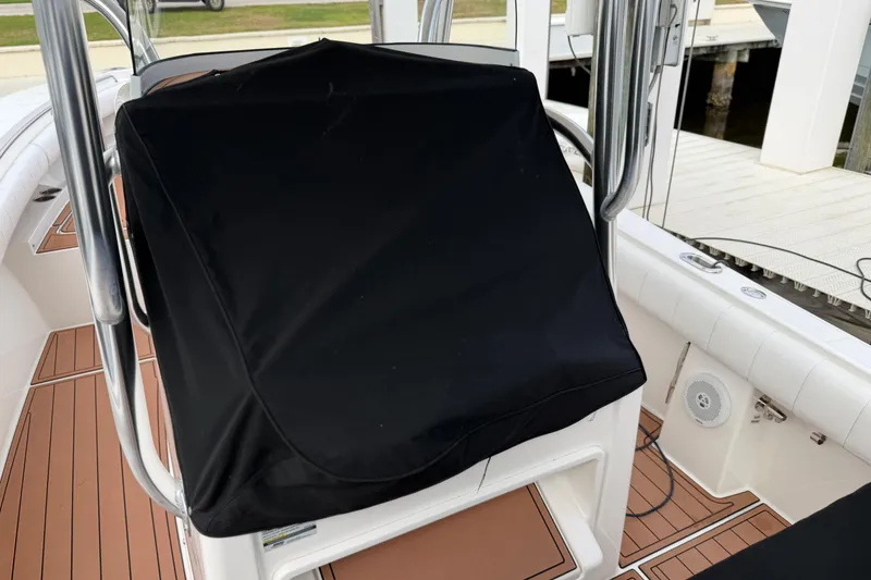 Slide: The Image of 2015 Regulator 25 boat cruising on a scenic waterway with luxury homes in the background. - 4