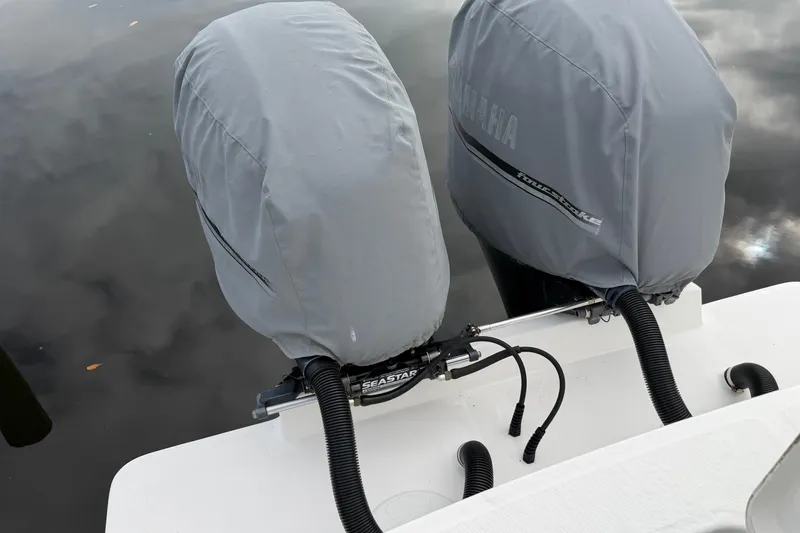 Slide: The Image of 2015 Regulator 25 boat cruising on open water under a partly cloudy sky. - 7