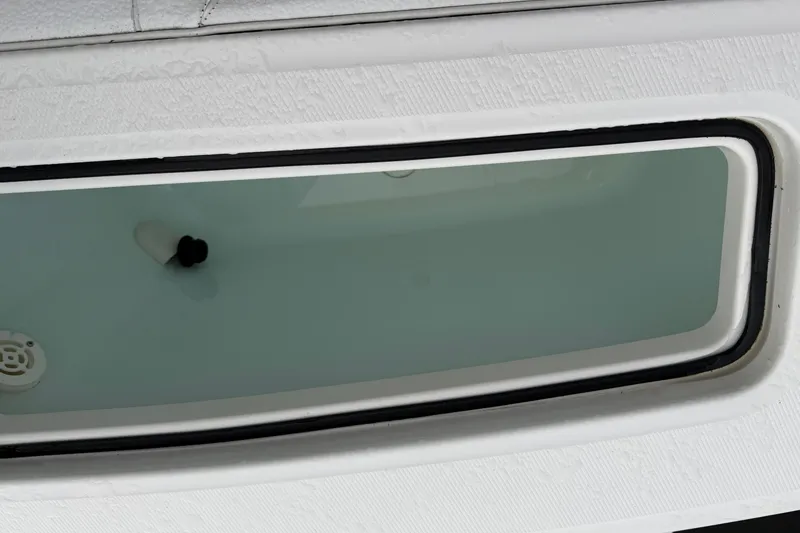 Slide: The Image of 2015 Regulator 25 boat with Yamaha engine docked on a sunny day. - 8