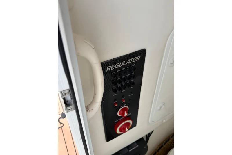 Slide: The Image of Overhead view of 2015 Regulator 25 boat with twin engines on water. - 9