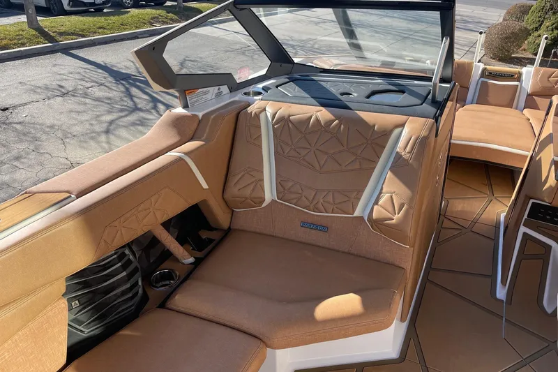 Slide: The Image of 2025 Nautique Super Air Nautique G25 Paragon interior with tan upholstery and modern design. - 10