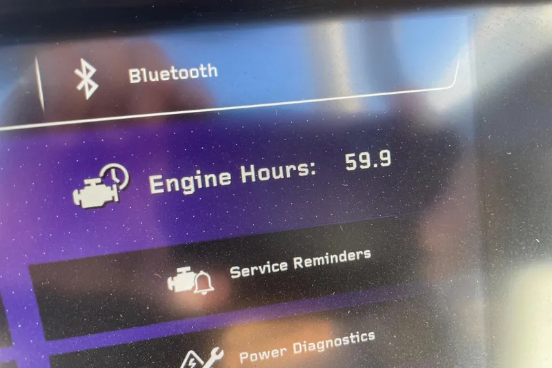 Slide: The Image of Display screen showing 59.9 engine hours on 2025 Nautique Super Air Nautique G25 Paragon. - 13