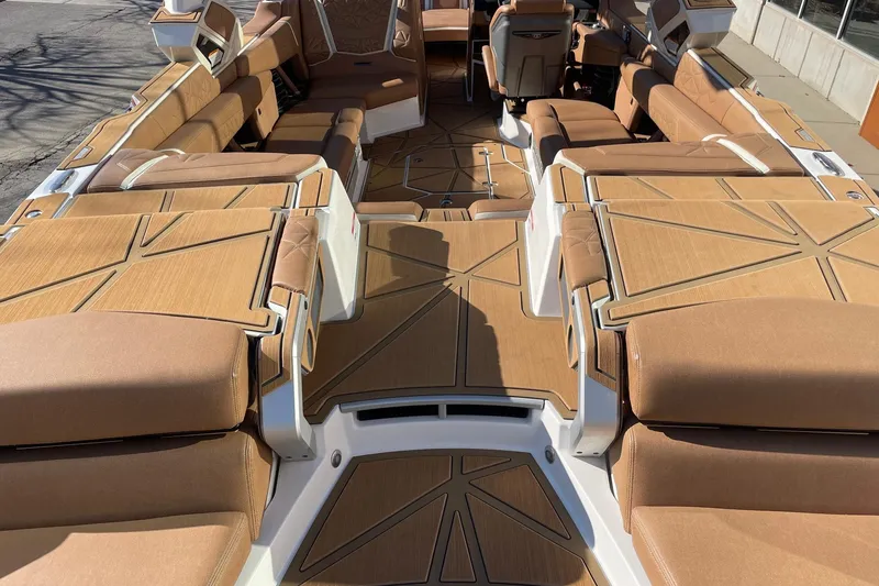 Slide: The Image of 2025 Nautique Super Air Nautique G25 Paragon interior with luxurious tan seating and deck. - 4