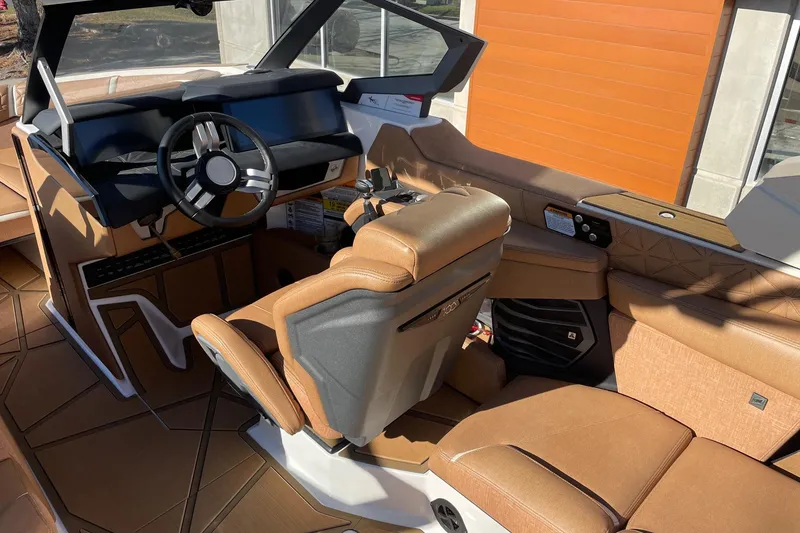 Slide: The Image of 2025 Nautique Super Air Nautique G25 Paragon interior with luxurious tan seating and modern dashboard. - 6
