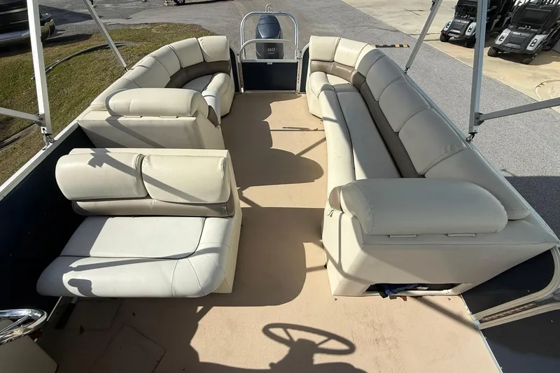 Slide: The Image of 2013 Silver Wave 220 Island CL pontoon boat with spacious seating and beige upholstery. - 10