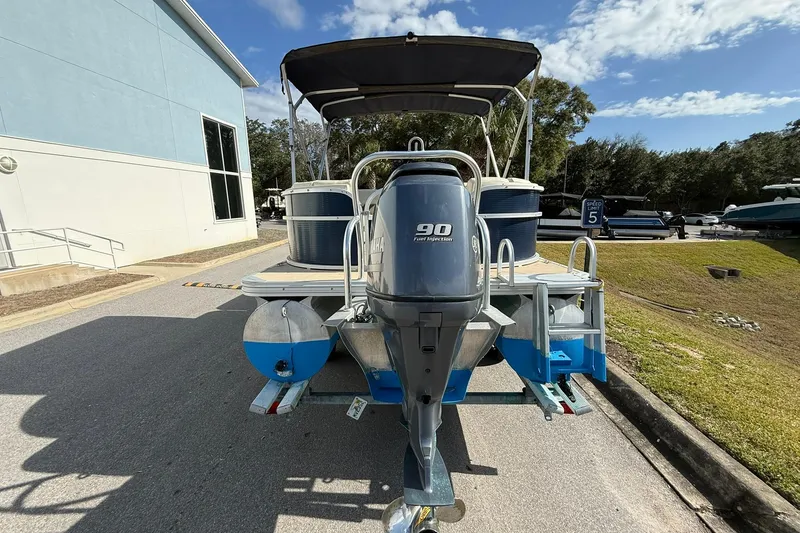 Slide: The Image of 2013 Silver Wave 220 Island CL pontoon boat with Yamaha 90 engine, parked outdoors. - 4