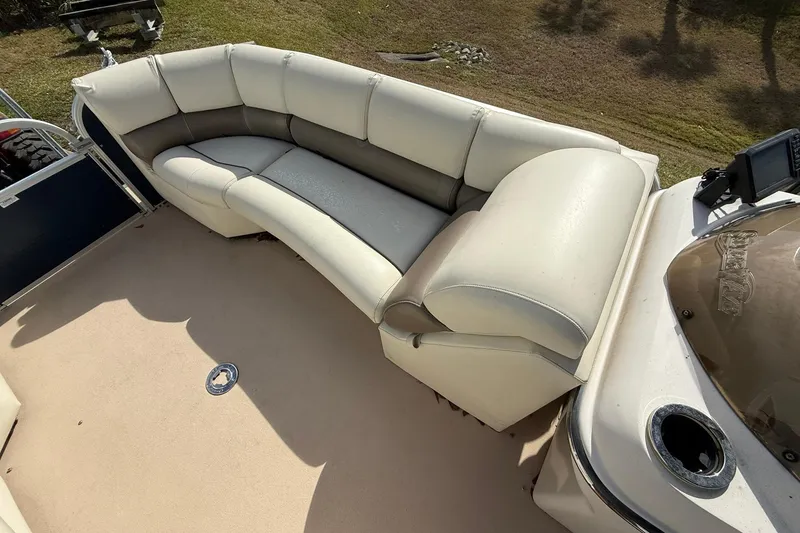 Slide: The Image of 2013 Silver Wave 220 Island CL boat with beige seating and spacious deck area. - 7