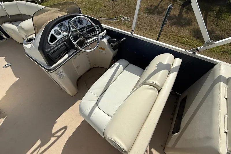 Slide: The Image of 2013 Silver Wave 220 Island CL boat interior with steering console and seating. - 9