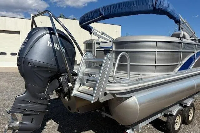 Slide: The Image of 2025 Bennington 22SXSR pontoon boat with Yamaha outboard motor on trailer. - 3