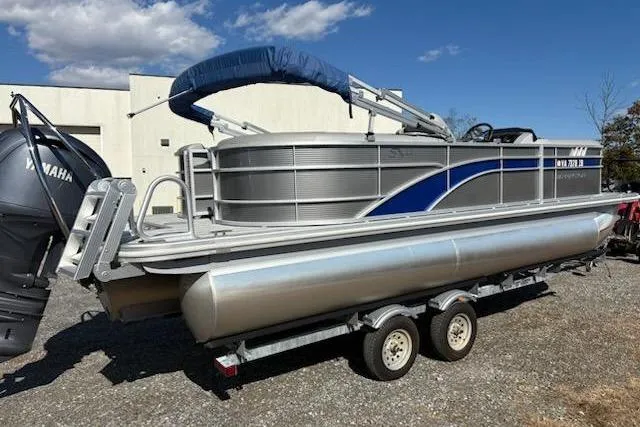Slide: The Image of 2025 Bennington 22SXSR pontoon boat on trailer, featuring Yamaha outboard motor. - 4