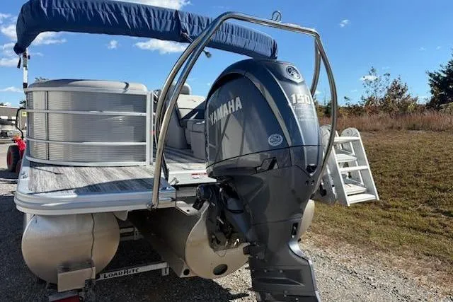 Slide: The Image of 2025 Bennington 22SXSR pontoon boat with Yamaha 150 engine, parked outdoors. - 6