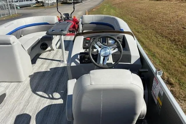 Slide: The Image of 2025 Bennington 22SXSR pontoon boat interior with steering wheel and seating. - 8