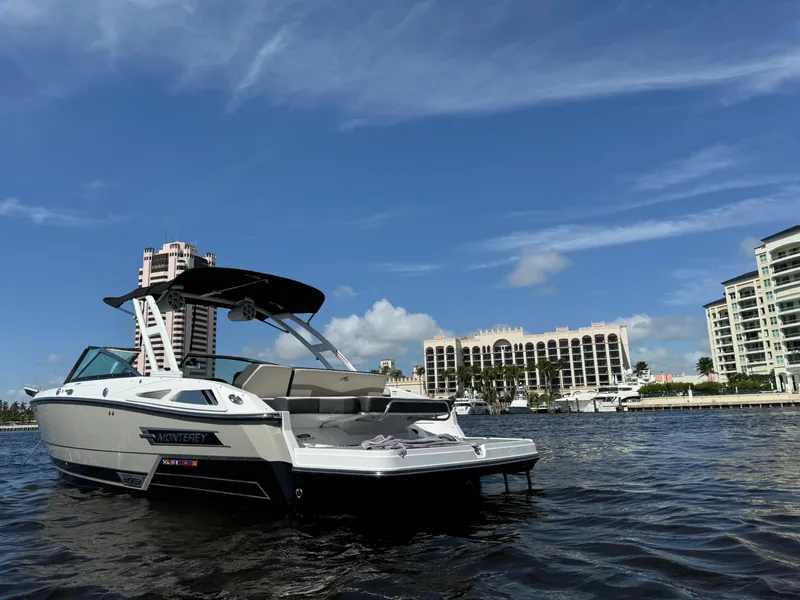 Slide: The Image of 2022 Monterey 278 Super Sport boat on water with city skyline in background. - 1