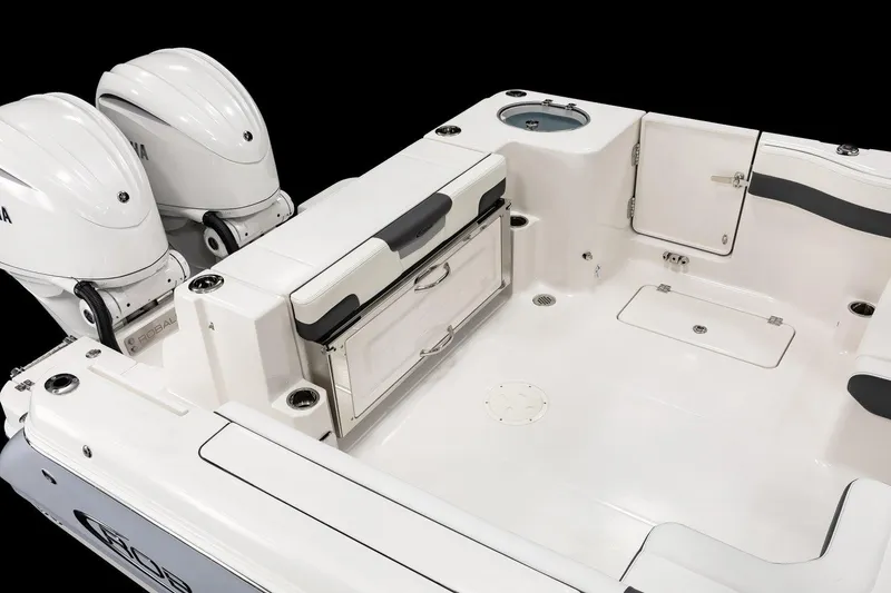 Slide: The Image of Manufacturer Provided Image: 2026 Robalo R277 Dual Console boat interior with twin engines and storage compartments. - 9