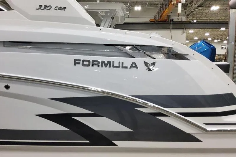 Slide: The Image of 2025 Formula 330 Crossover Bowrider I/O boat in a shipyard. - 13