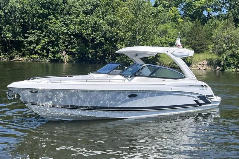 Slide: The Image of 2025 Formula 330 Crossover Bowrider I/O on a serene lake. - 19