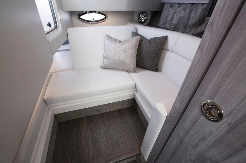 Slide: The Image of Manufacturer Provided Image: 2025 Formula 330 Crossover Bowrider I/O cabin interior with white seating and cushions. - 7