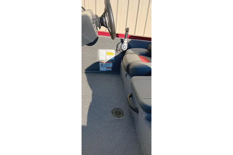 Slide: The Image of Interior of 2025 Tracker Pro Team 175 boat showing steering and seating area. - 15
