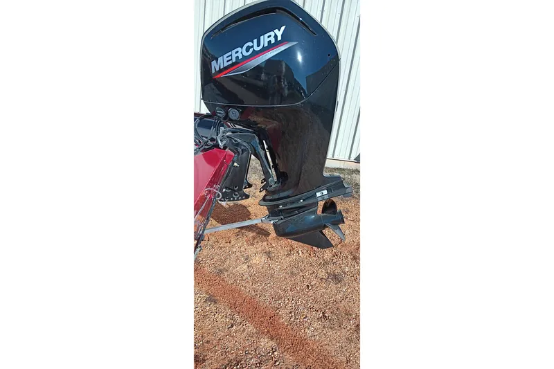 Slide: The Image of 2025 Tracker Pro Team 175 with Mercury outboard motor, parked on gravel. - 18