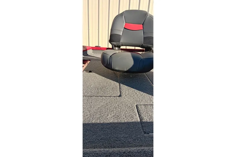 Slide: The Image of 2025 Tracker Pro Team 175 boat seat with gray and red upholstery. - 8