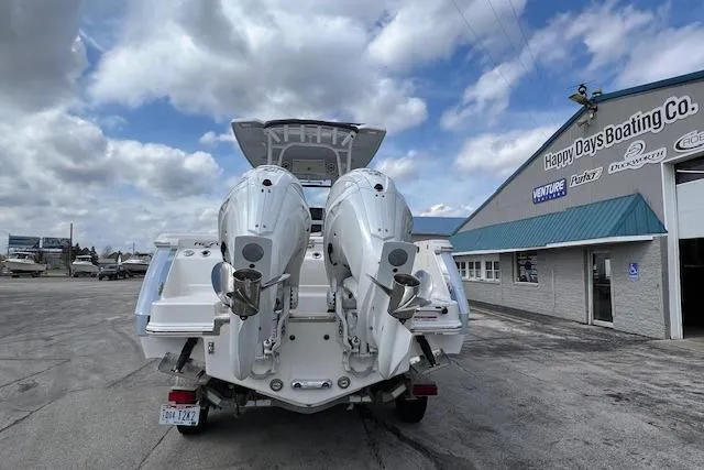 Slide: The Image of 2026 Robalo R270 Center Console boat with dual engines at Happy Days Boating Co. dealership. - 16