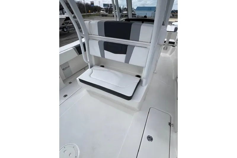 Slide: The Image of 2026 Robalo R270 Center Console boat interior with cushioned seating and storage compartments. - 18