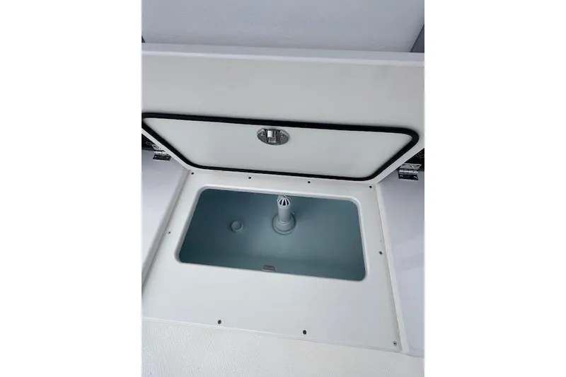 Slide: The Image of 2026 Robalo R270 Center Console livewell compartment, open lid view. - 19