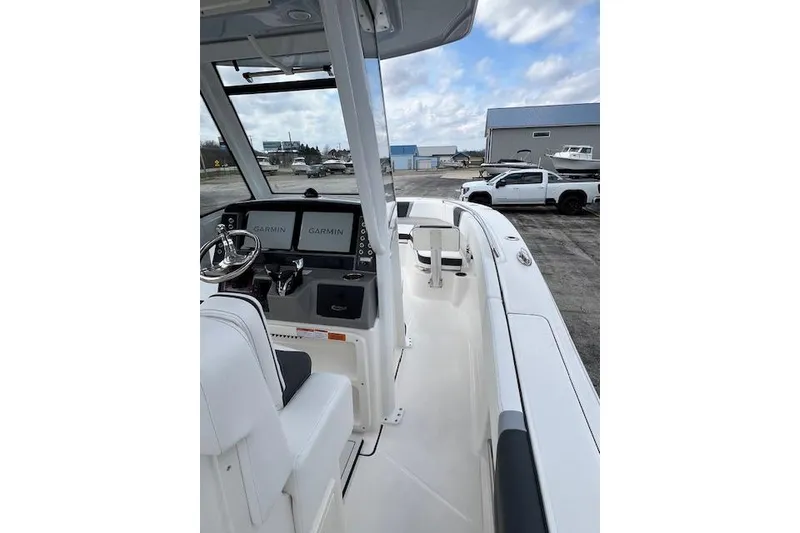 Slide: The Image of 2026 Robalo R270 Center Console boat with Garmin displays, parked near a truck. - 20