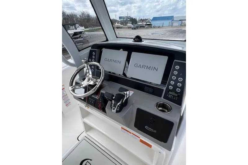 Slide: The Image of 2026 Robalo R270 Center Console helm with dual Garmin displays and steering wheel. - 21