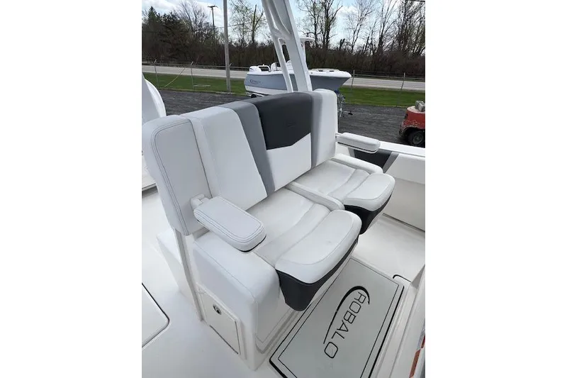 Slide: The Image of 2026 Robalo R270 Center Console boat seating with white and gray upholstery. - 23