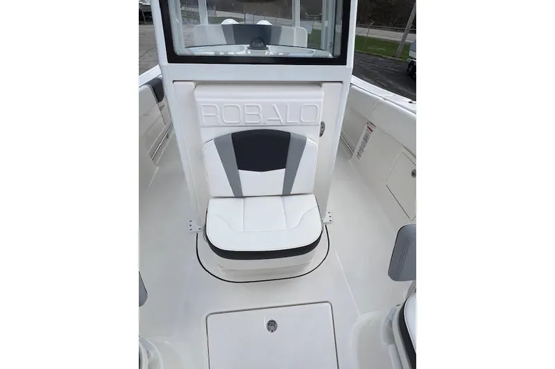 Slide: The Image of 2026 Robalo R270 Center Console boat interior with cushioned seating and sleek design. - 25