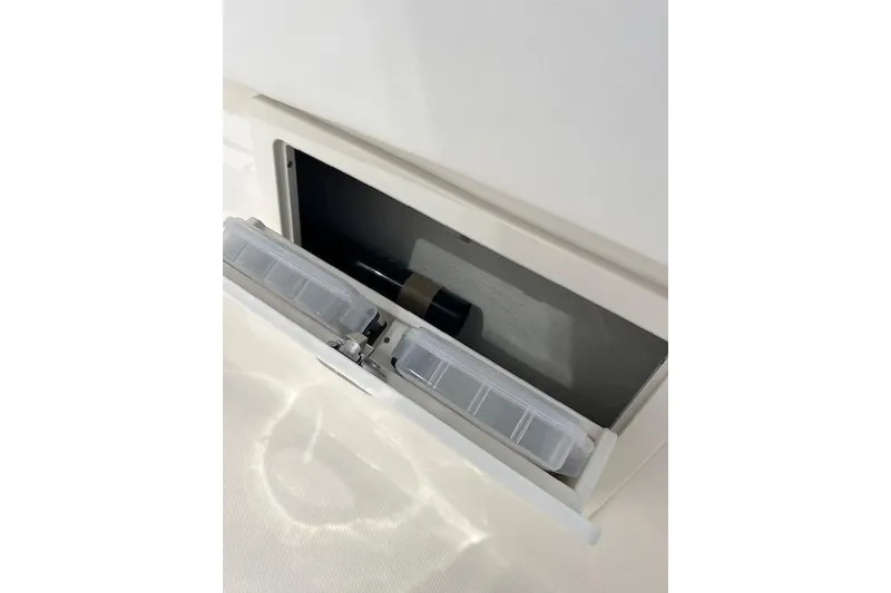 Slide: The Image of 2026 Robalo R270 Center Console storage compartment with tackle box. - 27