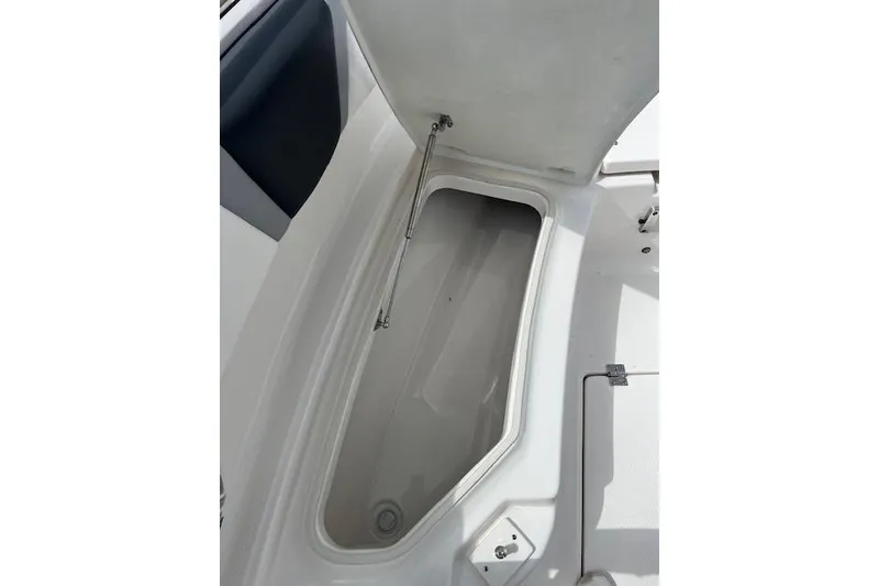 Slide: The Image of Open storage compartment on 2026 Robalo R270 Center Console boat. - 28