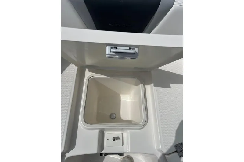 Slide: The Image of 2026 Robalo R270 Center Console boat storage compartment, open and empty. - 29