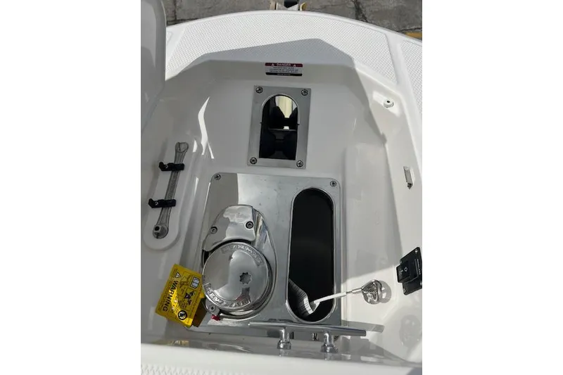 Slide: The Image of 2026 Robalo R270 Center Console boat compartment with tools and equipment. - 30