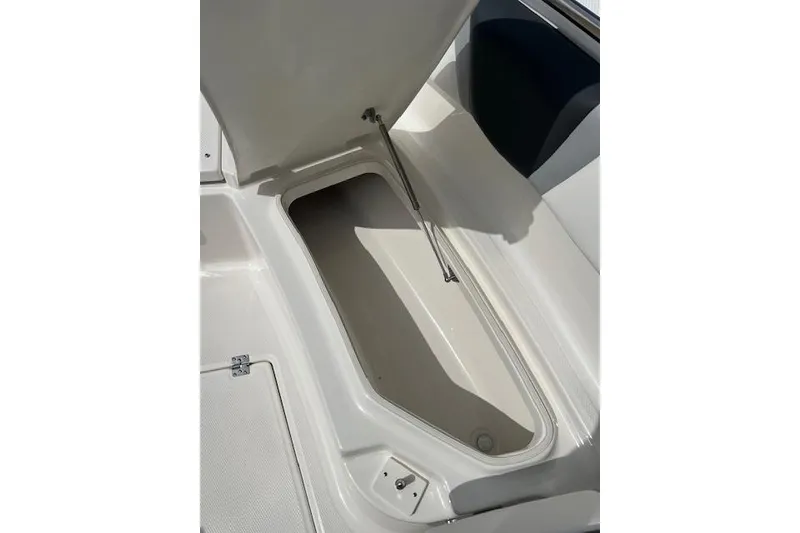 Slide: The Image of Open storage compartment on 2026 Robalo R270 Center Console boat. - 31