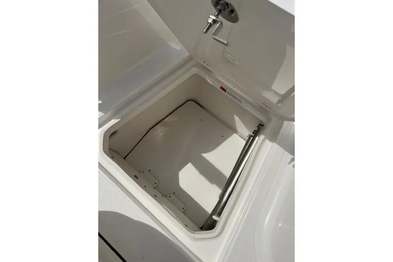 Slide: The Image of Open storage compartment on 2026 Robalo R270 Center Console boat. - 32
