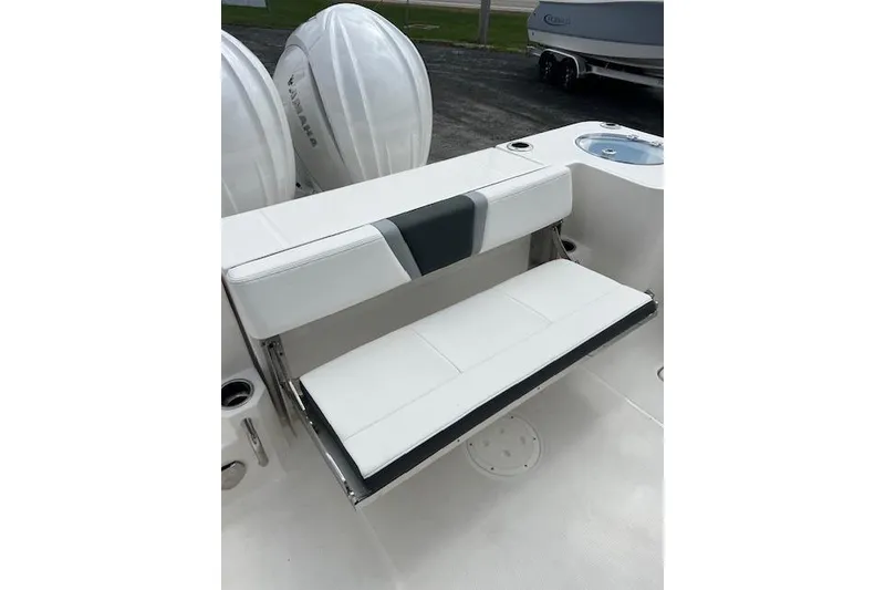 Slide: The Image of 2026 Robalo R270 Center Console boat with white seating and dual Yamaha engines. - 33