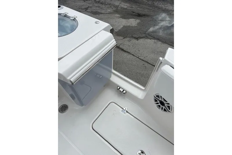 Slide: The Image of 2026 Robalo R270 Center Console boat interior with storage compartment and speaker. - 36