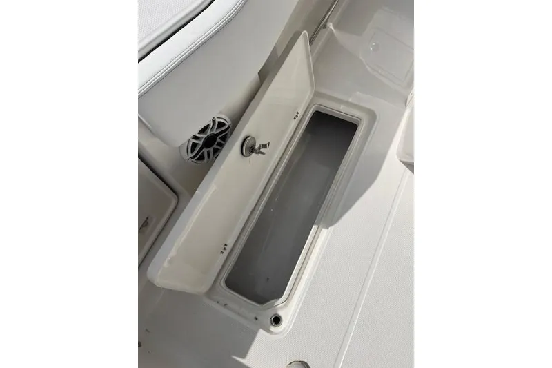 Slide: The Image of Open storage compartment on 2026 Robalo R270 Center Console boat deck. - 37