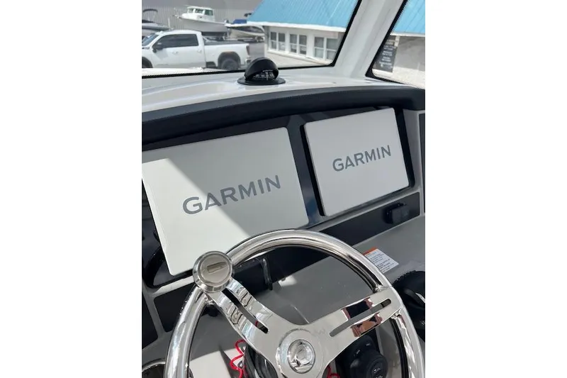 Slide: The Image of 2026 Robalo R270 Center Console with Garmin navigation displays and steering wheel. - 38