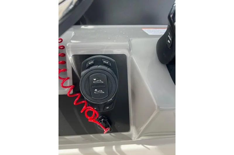 Slide: The Image of 2026 Robalo R270 Center Console boat control panel with red coiled cord. - 39