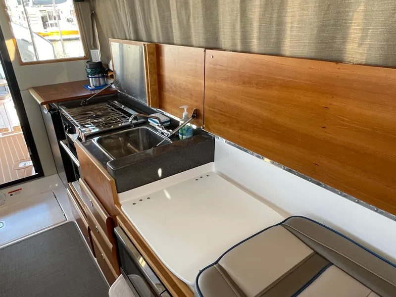Slide: The Image of Interior of 2019 Cutwater C-30 Sedan with kitchen and sink. - 18