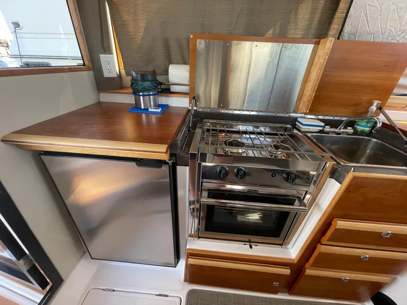 Slide: The Image of Interior of 2019 Cutwater C-30 Sedan with kitchen and fridge. - 21