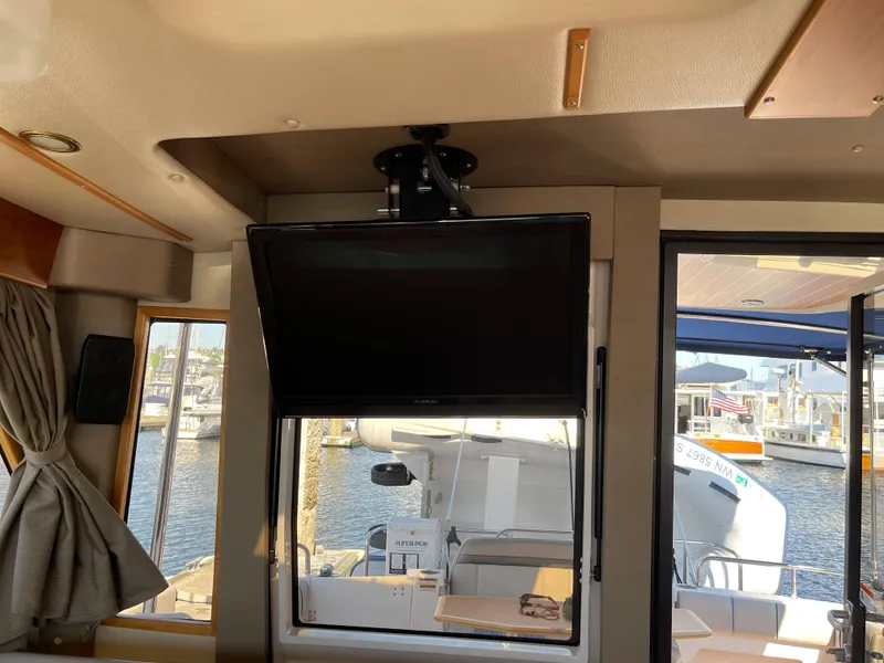 Slide: The Image of Interior of a 2019 Cutwater C-30 Sedan with TV and harbor view. - 30