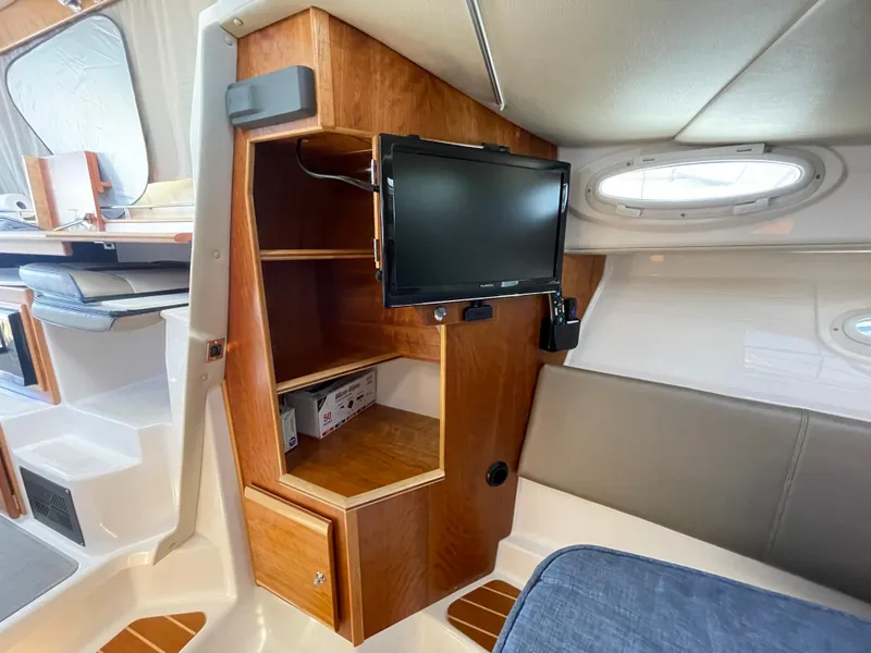Slide: The Image of Interior of 2019 Cutwater C-30 Sedan with TV and wooden shelving. - 9