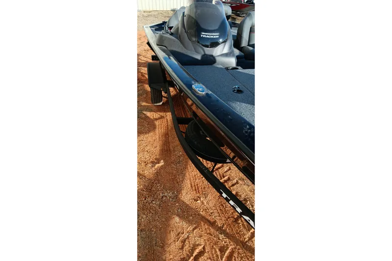 Slide: The Image of 2024 Tracker Pro Team 175 TXW boat on sandy ground, side view. - 12