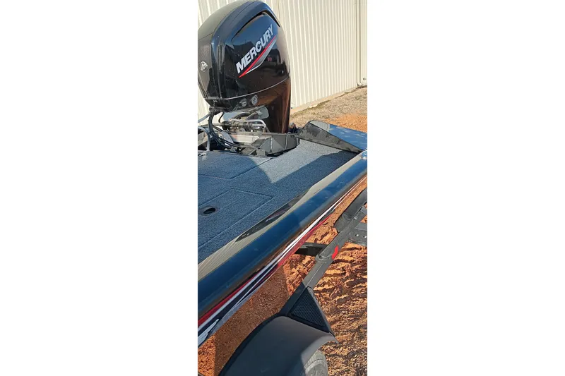 Slide: The Image of 2024 Tracker Pro Team 175 TXW boat with Mercury engine, parked outdoors. - 13