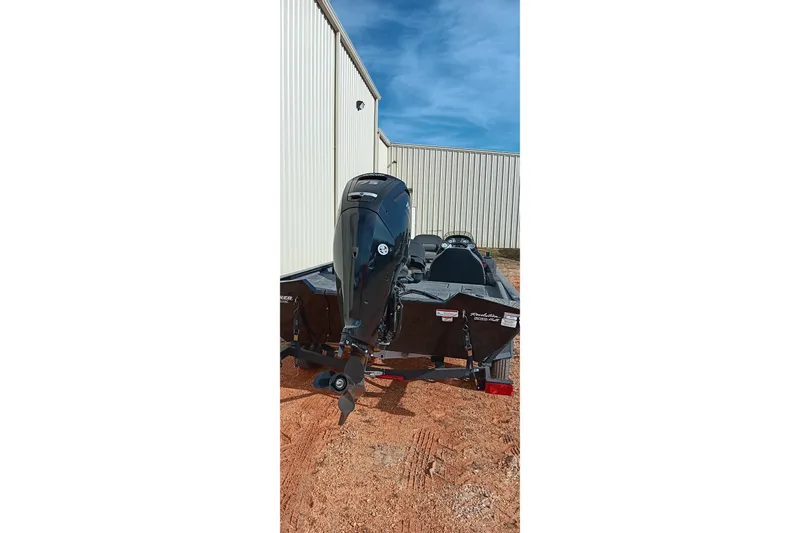 Slide: The Image of 2024 Tracker Pro Team 175 TXW boat with outboard motor, parked outdoors. - 15