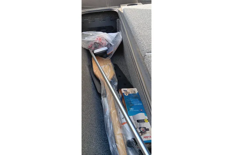 Slide: The Image of Storage compartment of 2024 Tracker Pro Team 175 TXW boat with equipment and accessories. - 18